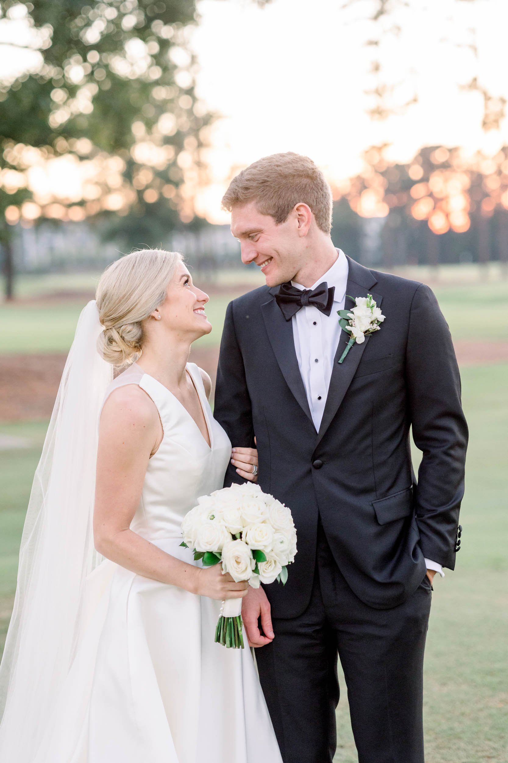 Bride and groom standing on the lawn at Cape Fear Country Club, photographed by Cape Fear Country Club wedding photographers.