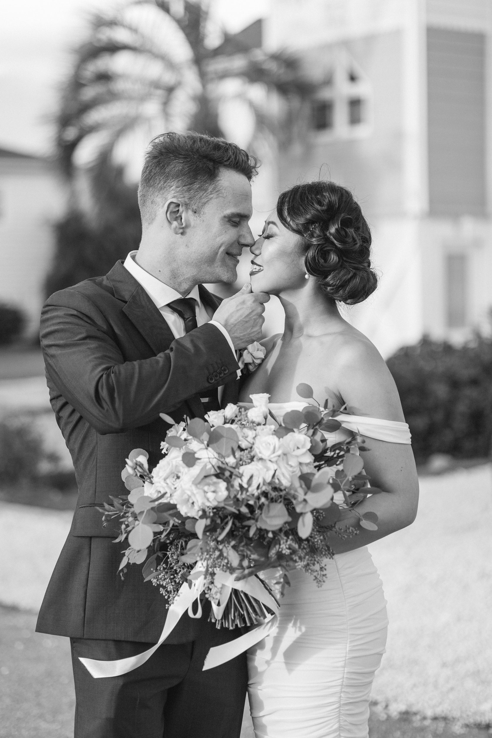 Black and white portrait of a bride and groom sharing a quiet moment, captured by Wilmington NC wedding photographers.