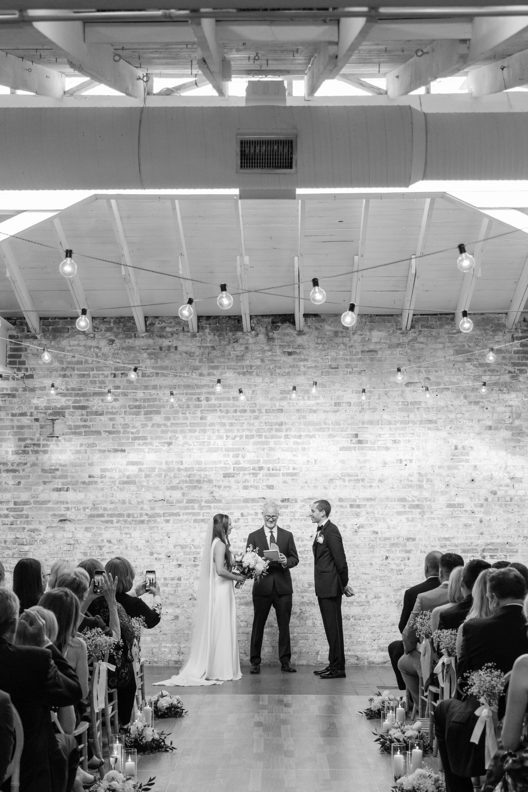 Bride and groom during their ceremony inside Bakery 105, photographed by Bakery 105 wedding photographers in Wilmington NC.