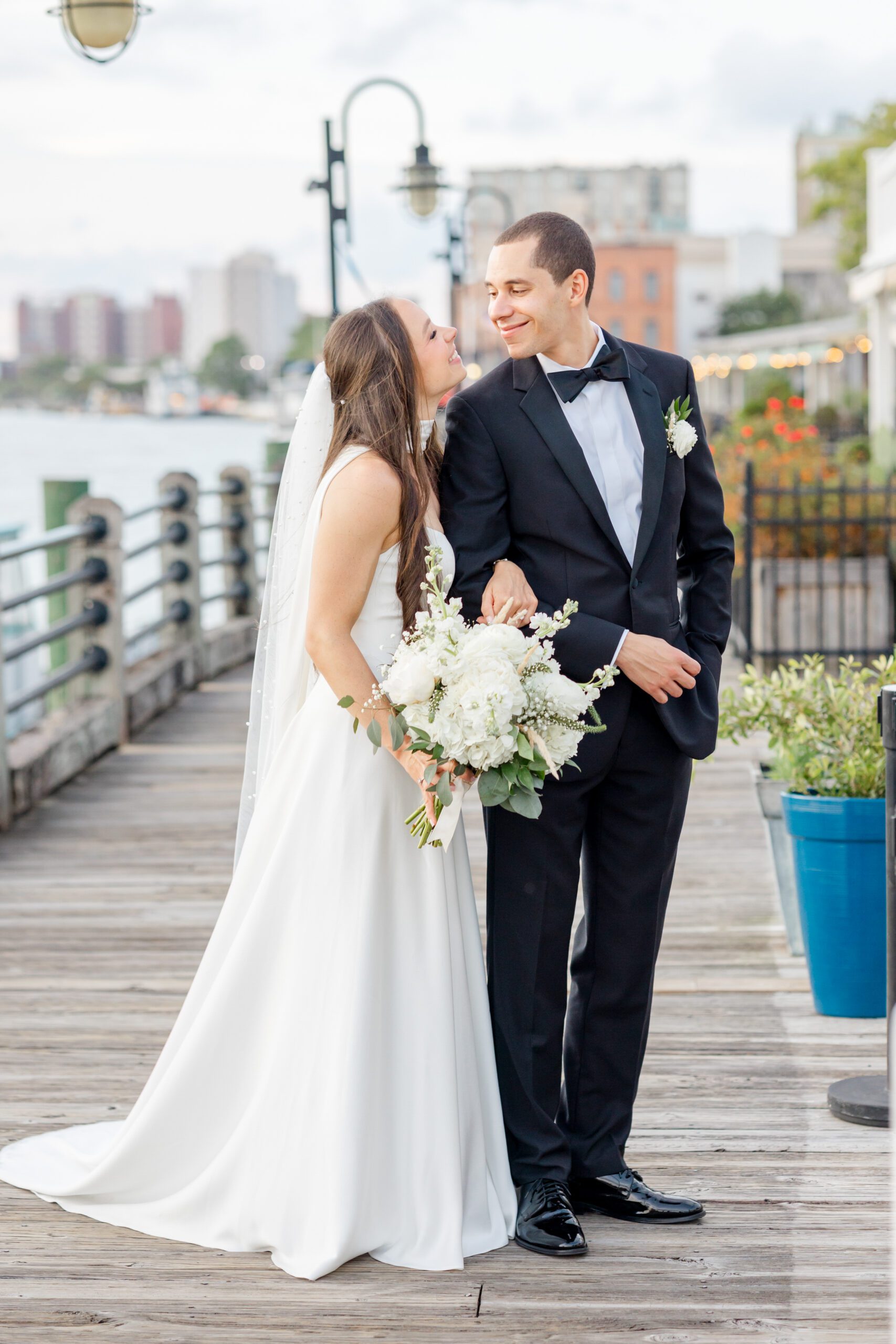 Candid moment of the bride and groom laughing together in downtown Wilmington, photographed by Bakery 105 wedding photographers.