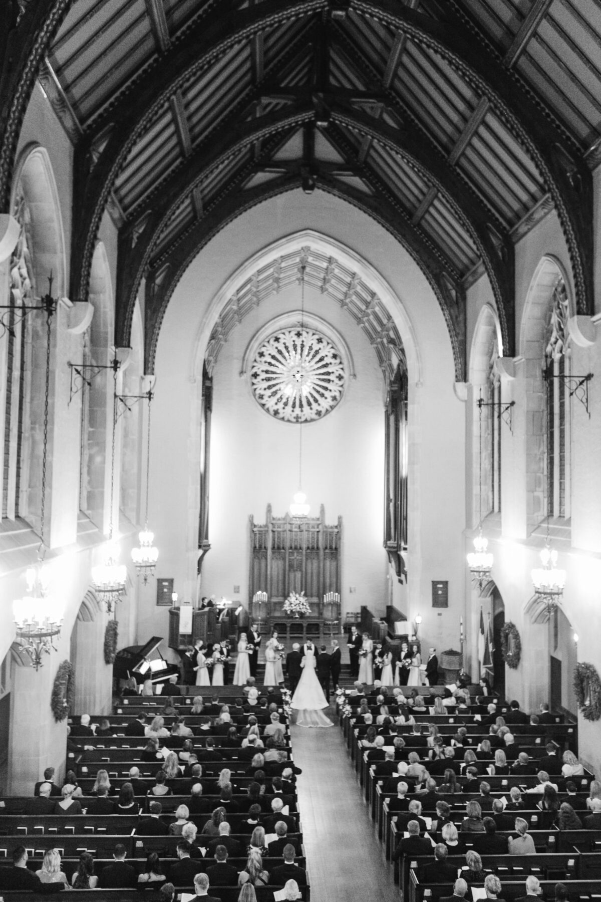 wedding ceremony inside a historic church in Wilmington NC with guests gathered and the couple exchanging vows