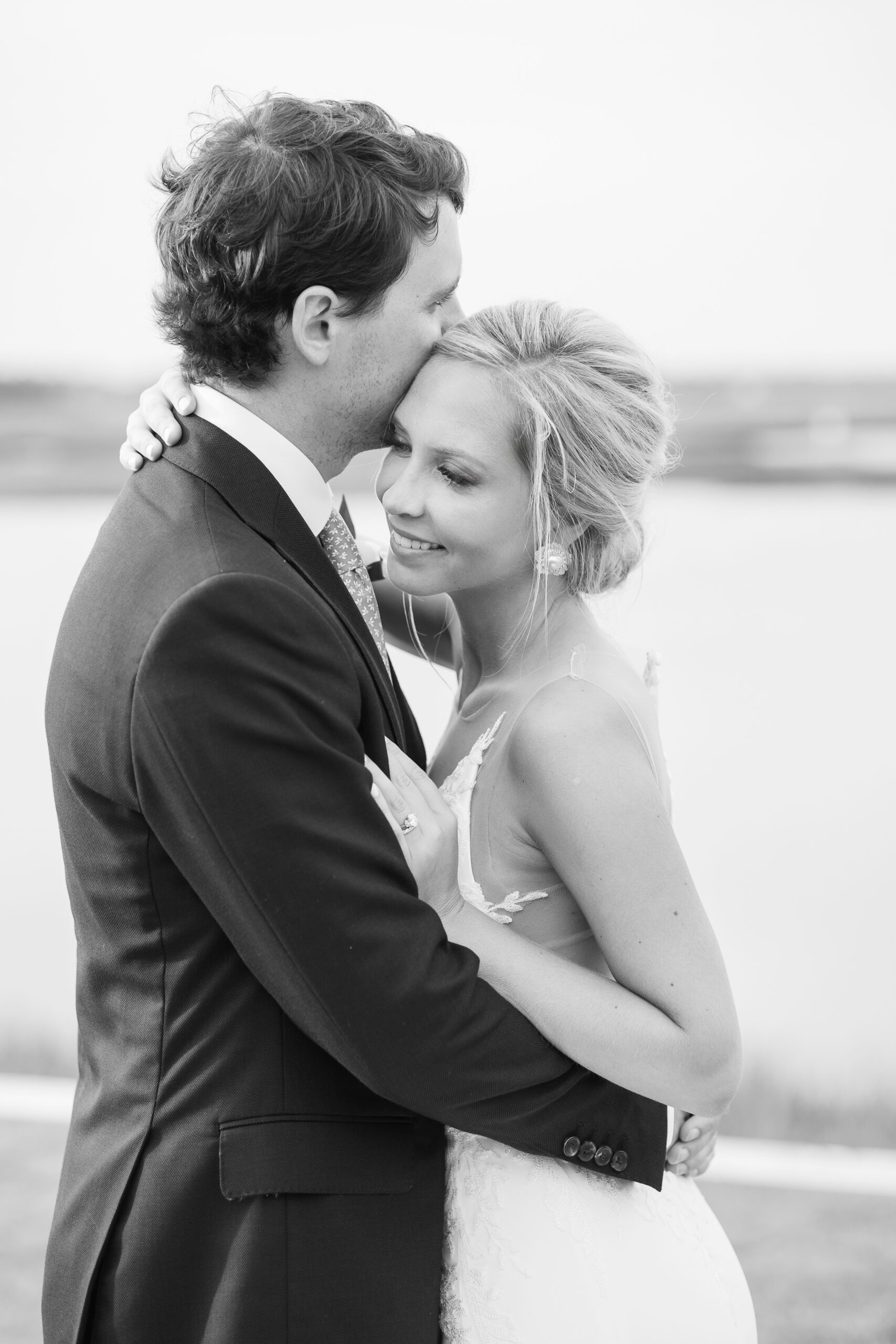 bride and groom embracing during their wedding at Figure Eight Island for their Wilmington NC wedding