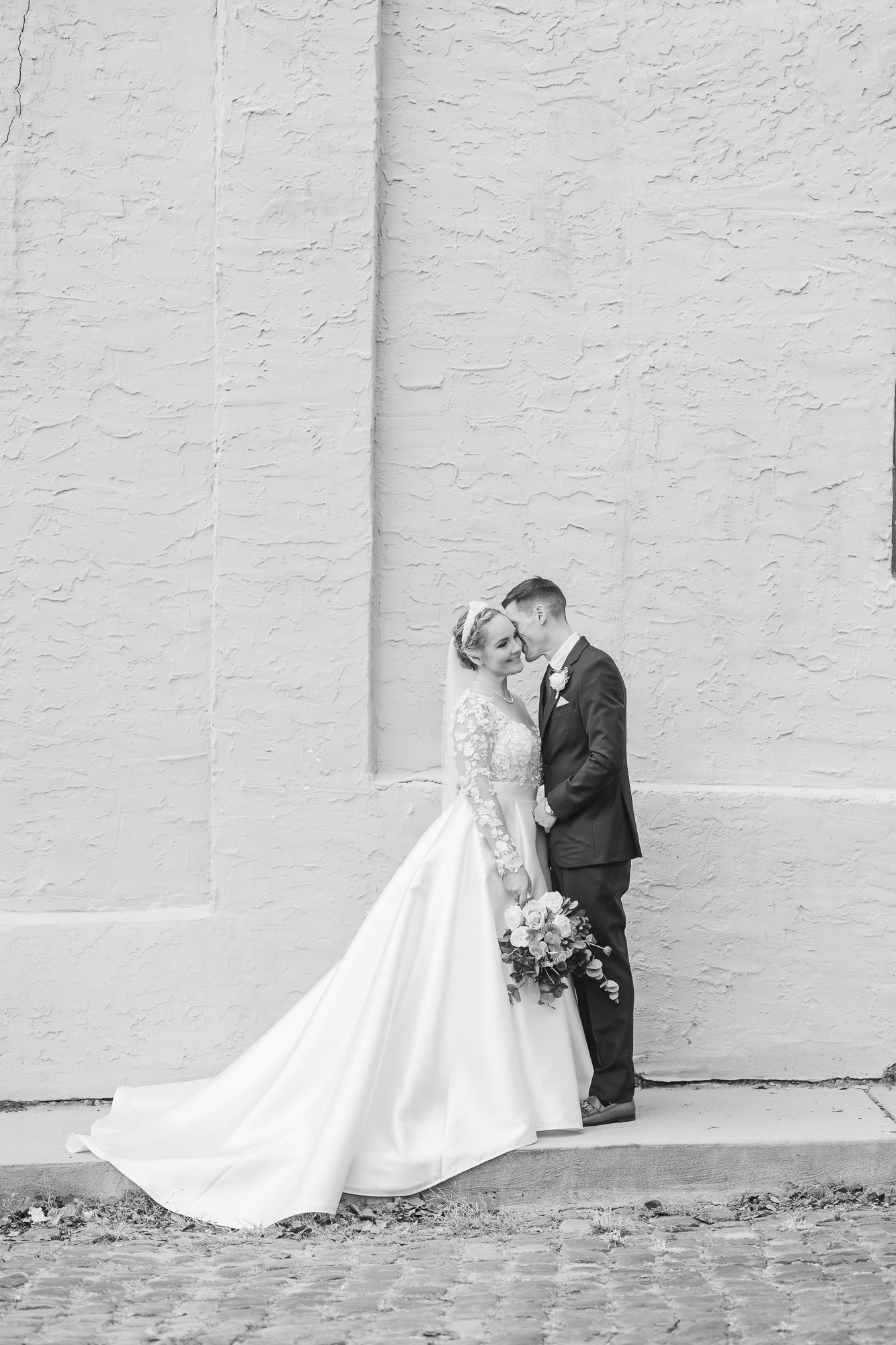 Bride and groom standing by the historic brick exterior for their 128 South Wedding in Wilmington NC
