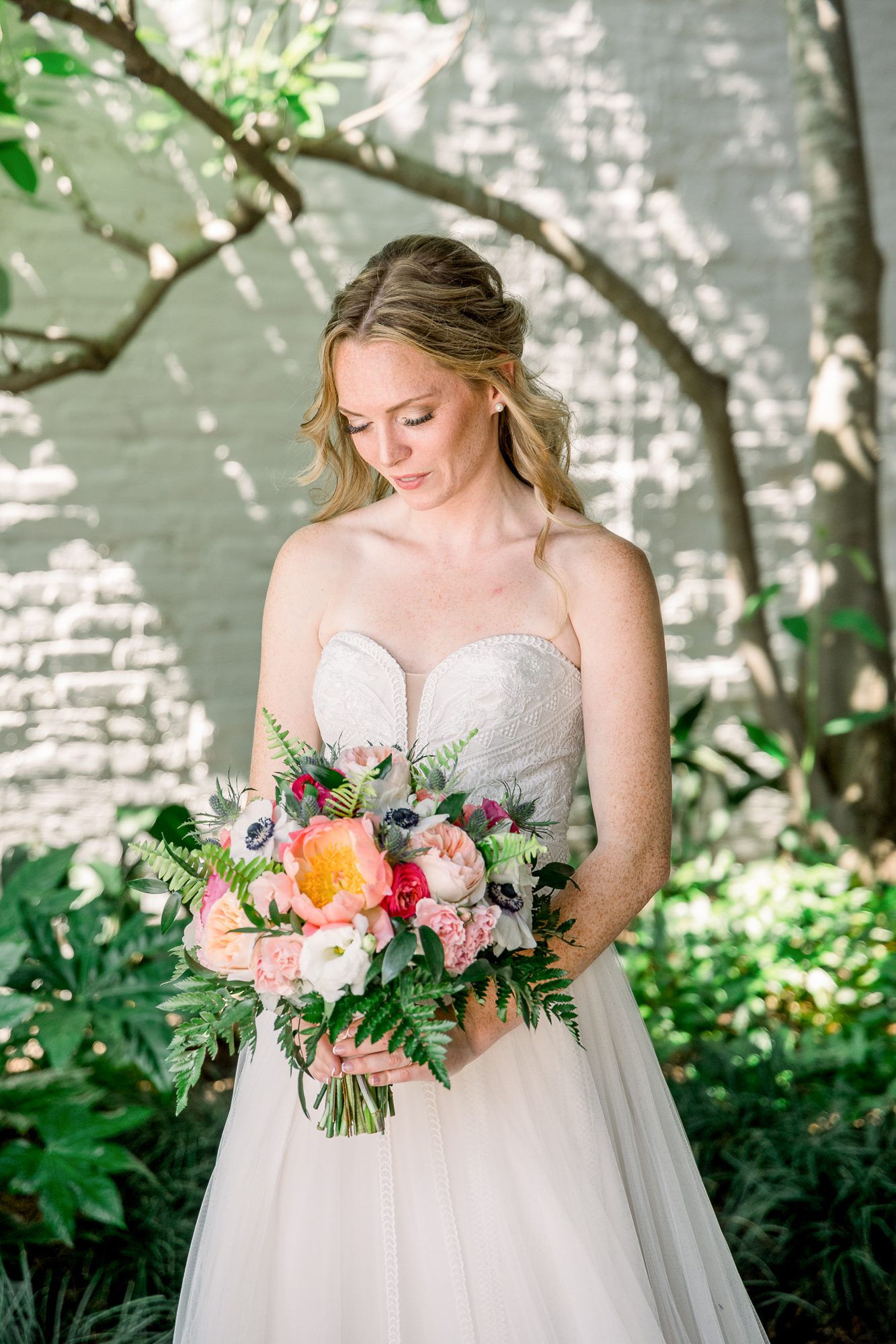 Bridal portrait in downtown Wilmington NC with soft natural light and garden backdrop