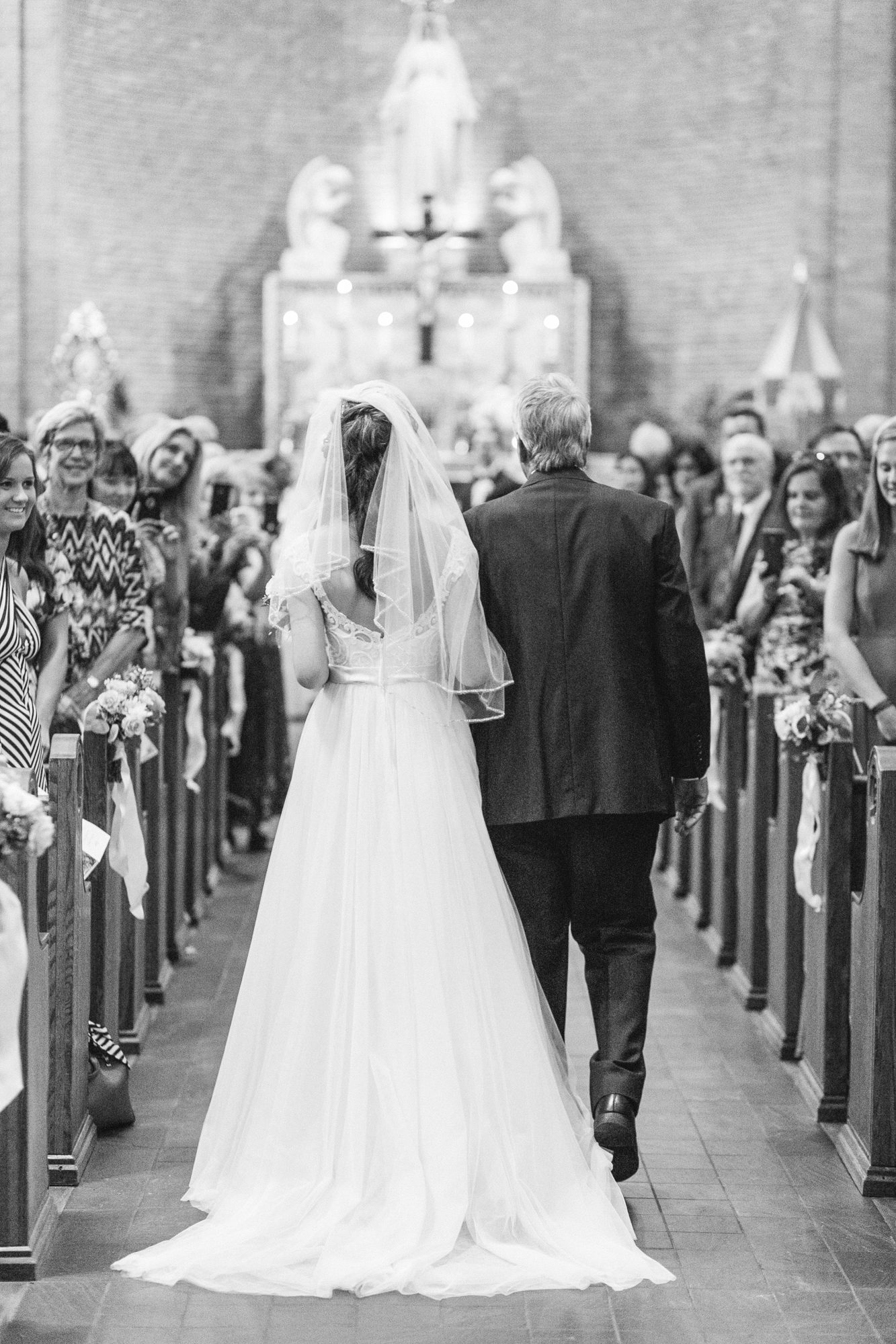 bride walks down the aisle for her ceremony at st. mary's catholic church in wilmington nc