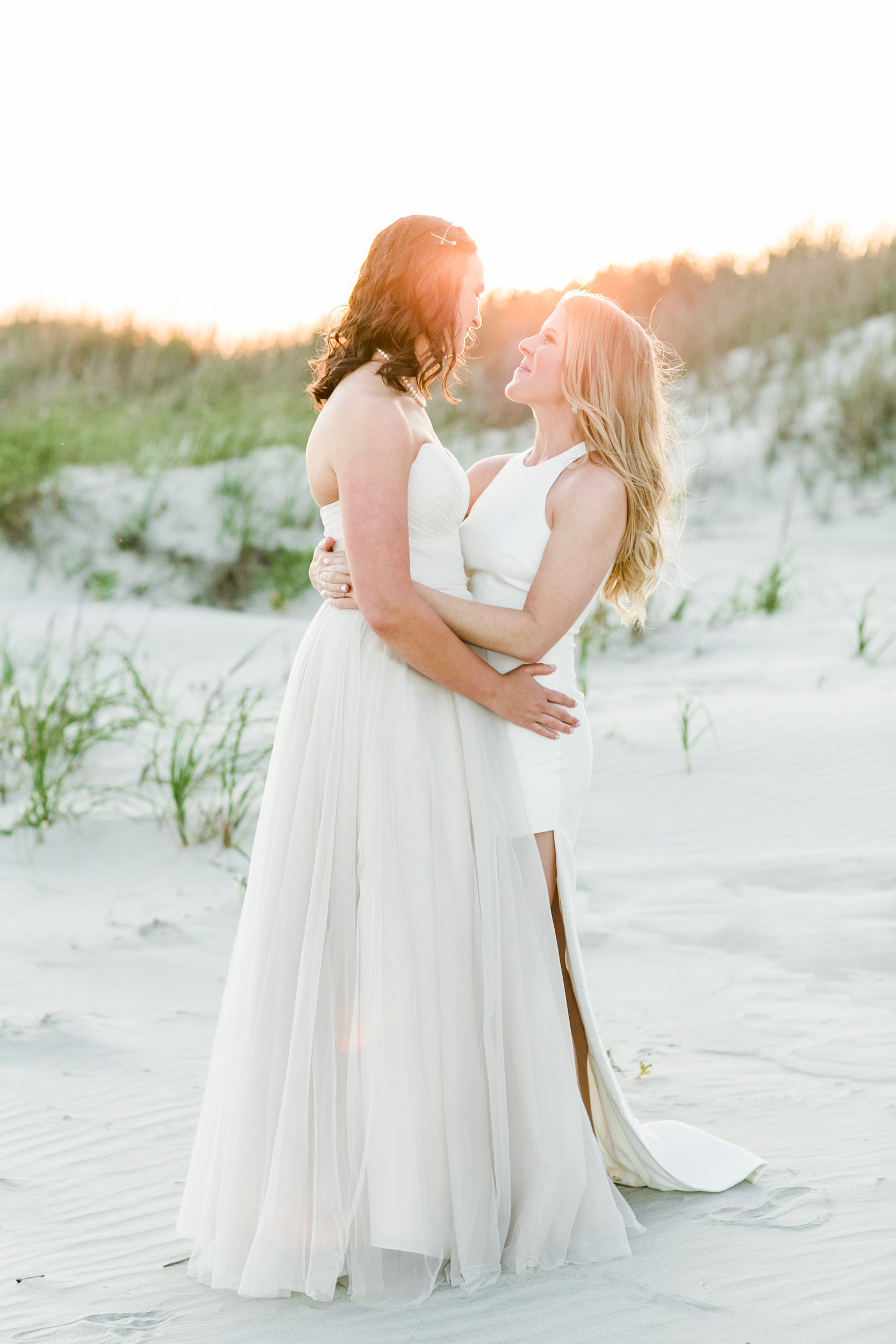 Wedding portraits of two brides walking on Wrightsville Beach