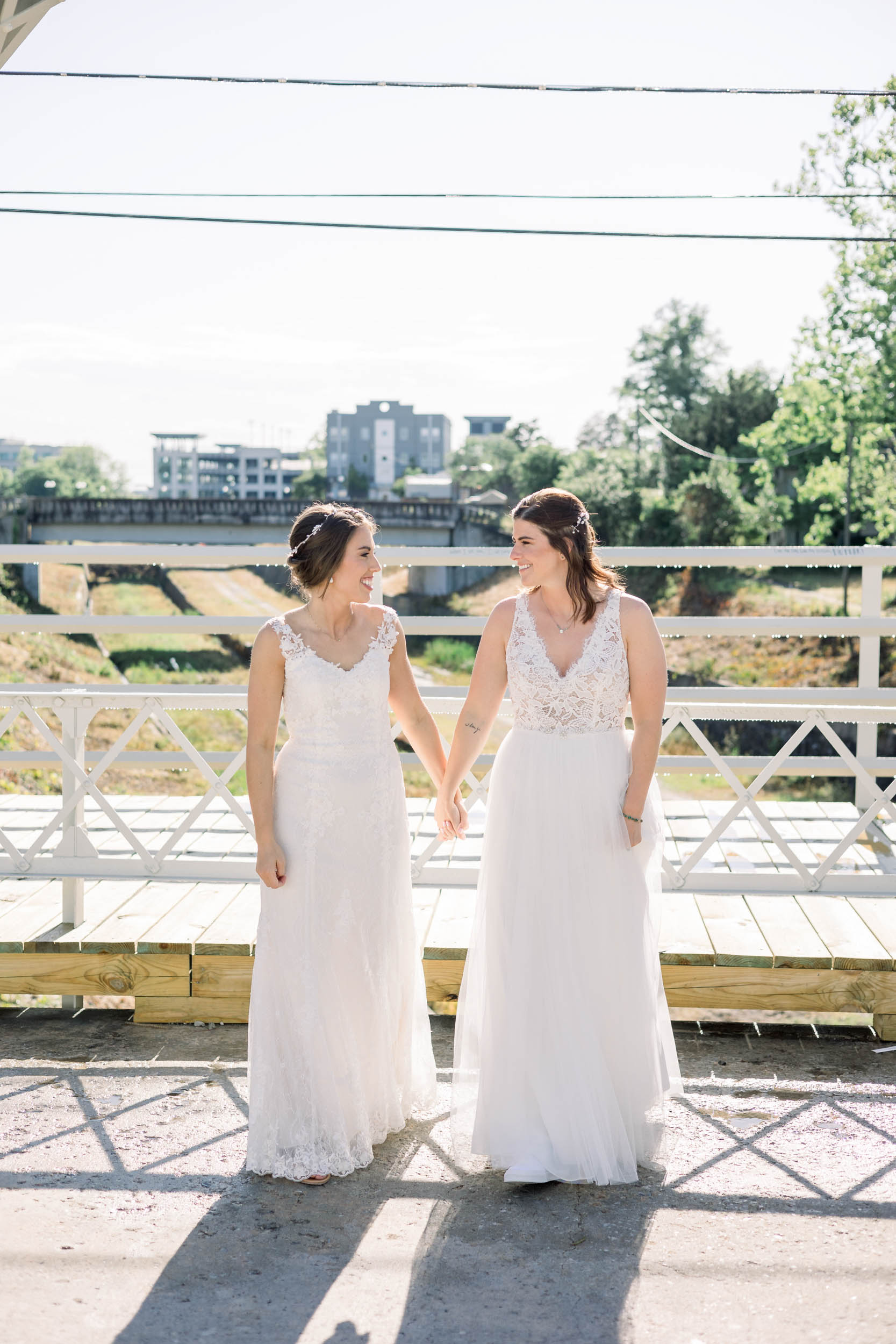 Two brides walking together at Brooklyn Arts Center wedding in Wilmington